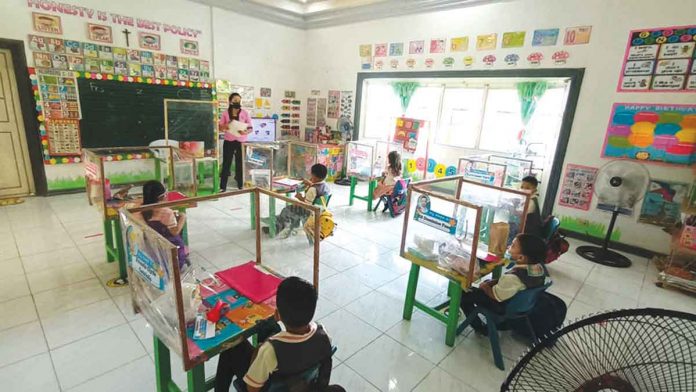 Learners observe physical distancing while attending classes at the Oxmont Memorial Academy in Calinog, Iloilo.