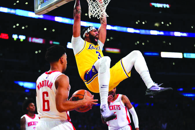 Los Angeles Lakers forward Anthony Davis (3) dunks for a basket in front of Houston Rockets forward Kenyon Martin Jr. (6) at the Staples Center. PHOTO BY GARY A. VASQUEZ-USA TODAY SPORTS