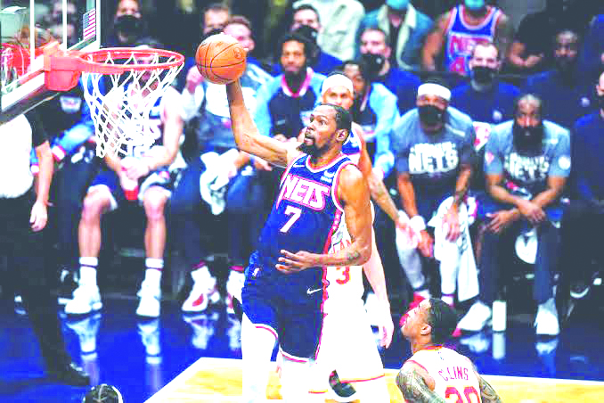 Brooklyn Nets’ Kevin Durant (7) drives past Atlanta Hawks’ John Collins (20) in the first half of their NBA basketball game on Nov. 3, 2021, in New York. AP PHOTO/FRANK FRANKLIN II