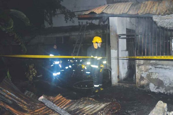 Arson investigators cordon the fire-hit candle factory in Barangay Bantud, La Paz, Iloilo. PANAY NEWS PHOTO