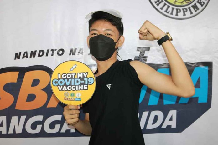 A teenager proudly shows his vaccinated arm. The city government of Roxas started pediatric vaccination against coronavirus disease 2019 on Nov. 10, 2021.