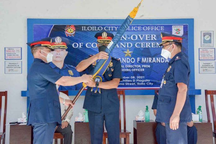 The outgoing Iloilo City Police Office (ICPO) director, Police Colonel Uldarico Garbanzos, turns over the ICPO flag to Police Colonel Leo Batiles. The turnover is led by Police Brigadier General Rolando Miranda, regional police director.