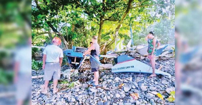 Fishermen of Libertad, Antique check their boats that the storm surge brought by super typhoon “Odette” destroyed. PHOTO FROM FACEBOOK PAGE OF MAYOR BEBOT NICOPIOR TE