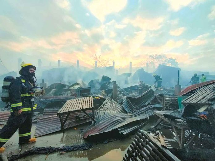 A firefighter surveys what’s left of the public market of Oton, Iloilo that fire gutted before dawn on Monday. The Bureau of Fire Protection’s initial estimate of the damage reached P44 million. PN PHOTO