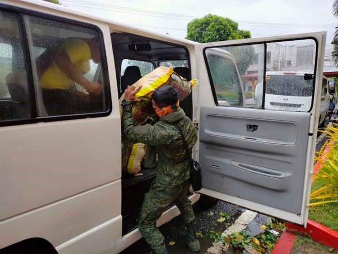 A Philippine Army soldier carries to a waiting vehicle a sack of relief goods for distribution to people displaced by super typhoon “Odette”. PHOTO FROM PROVINCE OF ANTIQUE FACEBOOK PAGE