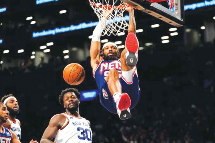 Brooklyn Nets guard DeAndre Bembry (95) dunks past New York Knicks forward Julius Randle (30) during the second half of an NBA basketball game on Nov. 30, 2021, in New York. AP PHOTO, MARY ALTAFFER