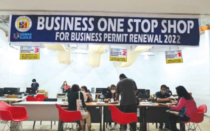 Clients apply for renewal of business permits at the Business One Stop Shop (BOSS) of the Iloilo City government in Mandurriao district. Four offsite BOSS branches in malls will accept renewal applications without penalties until Jan. 20, 2022. PHOTO FROM PNA, LEDIP