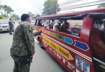 A police officer in Iloilo City makes sure passengers of this public utility jeepney are observing physical distancing. The Land Transportation Office and Land Transportation Franchising and Regulatory Board are eyeing 70 percent maximum seating capacity in jeepneys. PN Photo