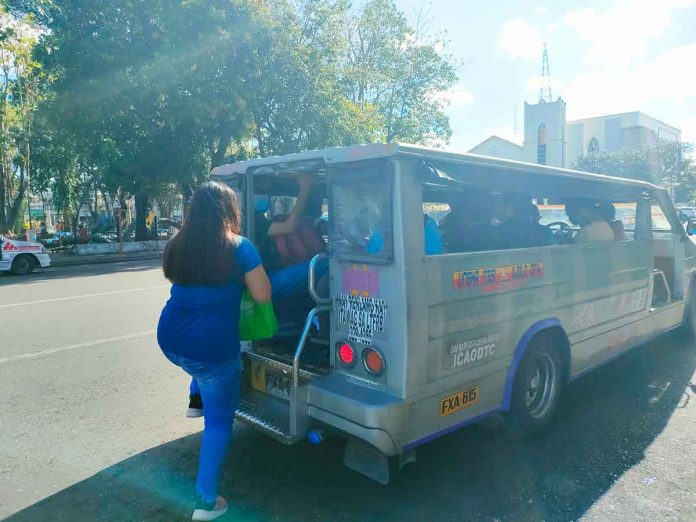 A woman boards a passenger jeepney in Jaro, Iloilo City. To ensure physical distancing, jeepneys here may only accommodate passengers to a maximum of 70 percent of their seating capacity. PN PHOTO