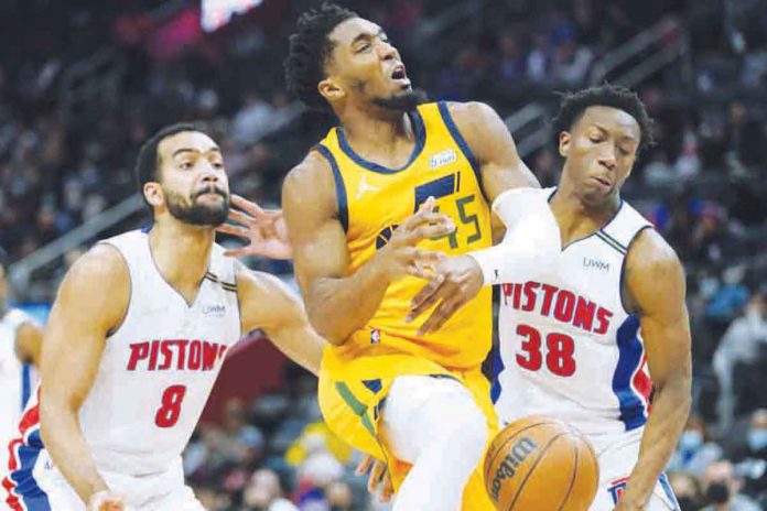 Utah Jazz’s Donovan Mitchell (45) loses the ball after being swiped by Detroit Pistons' Saben Lee (38). PHOTO BY CARLOS OSORIO/AP