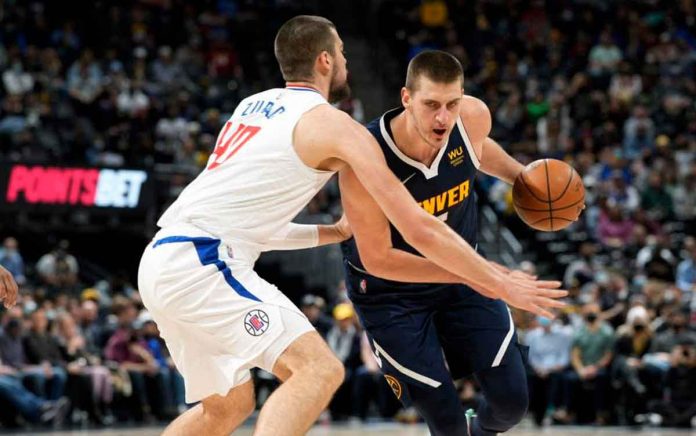 Denver Nuggets center Nikola Jokić (right), drives the lane as Los Angeles Clippers center Ivica Zubac defends in the first half of an NBA basketball game Wednesday, Jan. 19, 2022, in Denver. AP PHOTO/DAVID ZALUBOWSKI