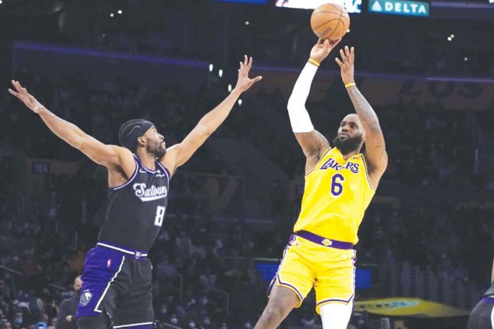 Los Angeles Lakers forward LeBron James (6) shoots over Sacramento Kings forward Maurice Harkless (8). Photo by Marcio Jose Sanchez / Associated Press