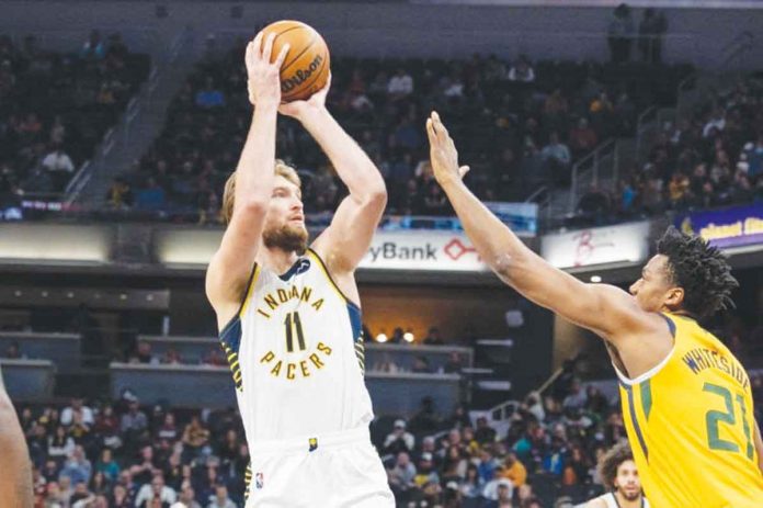 Indiana Pacers’ Domantas Sabonis shoots the ball while being defended by Utah Jazz’s Hassan Whiteside. USA TODAY PHOTO