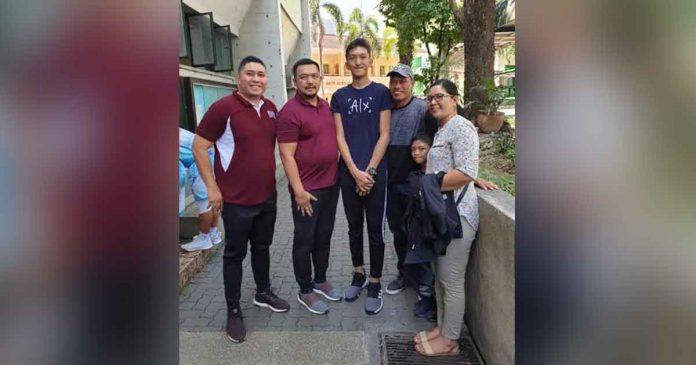 Heinz Gabriel Demisana is flanked by his relatives, UPIS team manager Dale Villajuan and UP Fighting Maroons program director Dolreich Perasol. CONTRIBUTED PHOTO