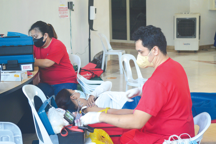 BLOOD DONATION. A nurse prepares a person with disability, a blood donor during Feb. 12’s bloodletting activity at the Iloilo provincial government. The noble act will surely serve as an inspiration to many. Donated blood is a priceless gift to those in need. PN PHOTO