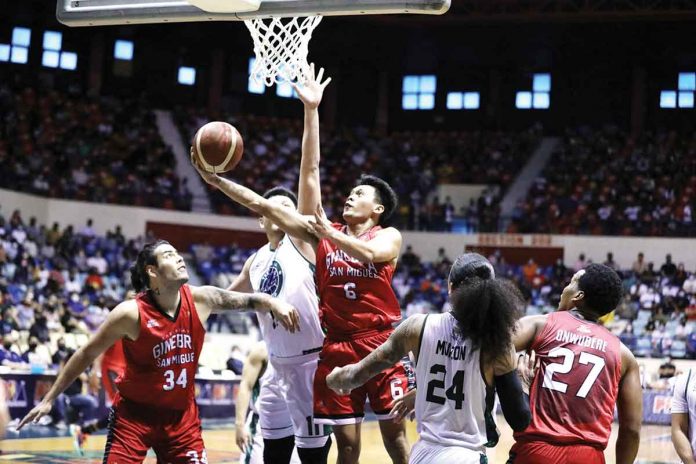 Barangay Ginebra San Miguel Kings’ Earl Scottie Thompson goes for a reverse basket against the defense of Terrafirma Dyip’s George Isaac Go. PBA MEDIA BUREAU