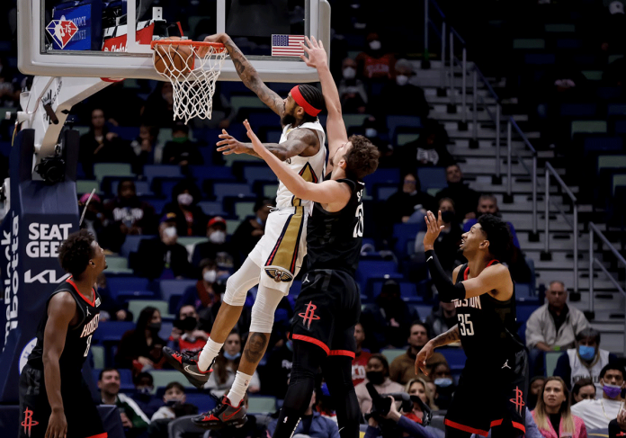 New Orleans Pelicans forward Brandon Ingram (No. 14) dunks over Houston Rockets center Alperen Sengun (No. 28) during the first quarter of an NBA basketball game in New Orleans. AP PHOTO/DERICK HINGLE