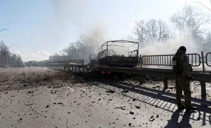 A damaged vehicle is seen at the site of a fighting with Russian raiding troops after Russia launched a massive military operation against Ukraine, in Kyiv, Ukraine February 26, 2022. REUTERS