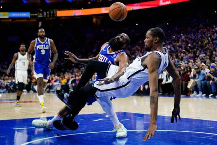 Philadelphia 76ers’ James Harden loses the ball after colliding against the defense of Brooklyn Nets forward Kevin Durant. AP PHOTO