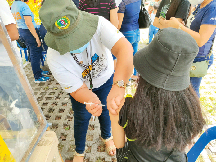 A youngster in Iloilo City gets her shot of the vaccine against coronavirus disease 2019. The city government is pressing for the vaccination of young people so that face-to-face classes can resume. PN PHOTO