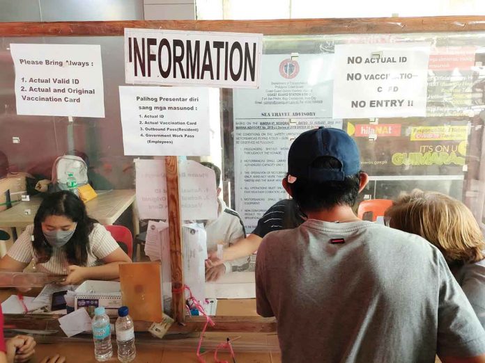 SCREENING. At Iloilo City’s Parola ferry terminal, a man bound for the island province of Guimaras submits his credentials – a valid identification card and COVID-19 vaccination card – to a screening booth. Without these, he won’t be allowed to cross the Iloilo Strait. Both Iloilo City and Guimaras province are under pandemic Alert Level 1. PN PHOTO