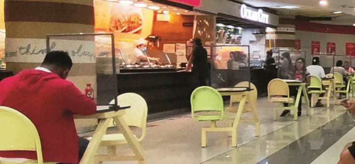 Every table in mall food court in Iloilo City has a plastic barrier to supposedly protect diners from coronavirus disease 2019. Plastic barriers also separate food kiosk cashiers from customers. PN PHOTO