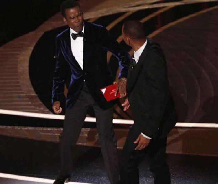 US actor Will Smith (R) swings at actor Chris Rock during the 94th annual Academy Awards ceremony at the Dolby Theatre in Hollywood, Los Angeles, California, USA, on March 27, 2022. Etienne Laurent, EPA-EFE