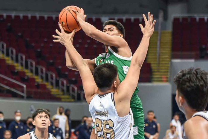 Negrense Mark Nonoy of De La Salle University Green Archers attacks the defense of National University Bulldogs center Germy Mahinay. UAAP MEDIA BUREAU