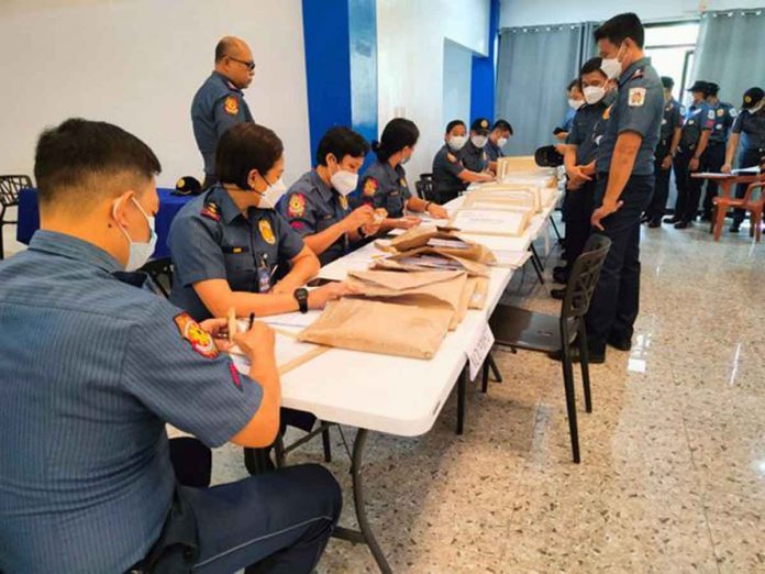 Negros Occidental policemen prepare for absentee voting at the Camp Alfredo Montelibano Sr. in Barangay Estefania, Bacolod City. They can only vote for national positions – president, vice president, senator, party-list. All of the ballots from the absentee voters will be submitted to the Commission on Elections central office in Metro Manila for counting.