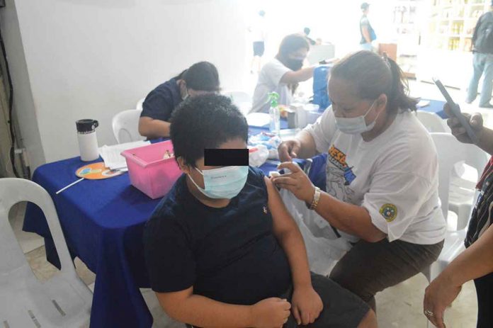 A youngster gets his dose of the vaccine against coronavirus disease 2019 at the Iloilo provincial capitol. Fearing a possible surge in infections after the elections, the provincial government is stepping up its vaccination drive. PN PHOTO