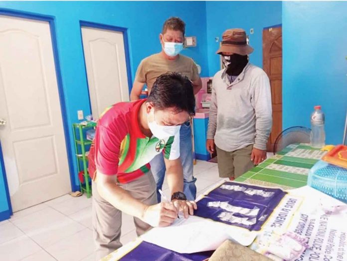 Policemen conduct an inventory of the items seized from a buy-bust operation in Purok Candelaria, Barangay Sum-ag, Bacolod City. PRO-6 PHOTO