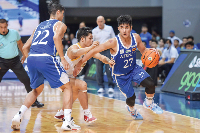 Bacolodnon Samjosef Belangel of Ateneo de Manila University Blue Eagles wards off the defense of University of Santo Tomas Growling Tigers' Jamba Garing. UAAP MEDIA BUREAU