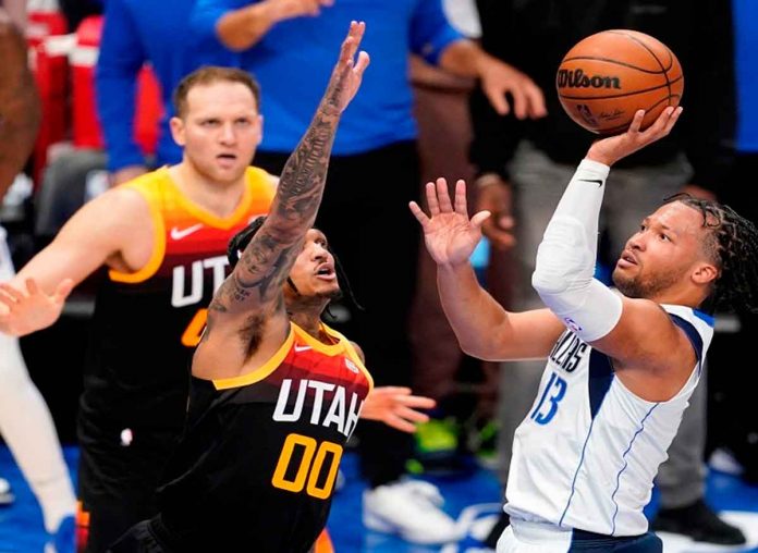 Dallas Mavericks’ Jalen Brunson attempts a one-hander against the defense of Filipino-American Jordan Clarkson of Utah Jazz. PHOTO BY TONY GUTIERREZ/AP