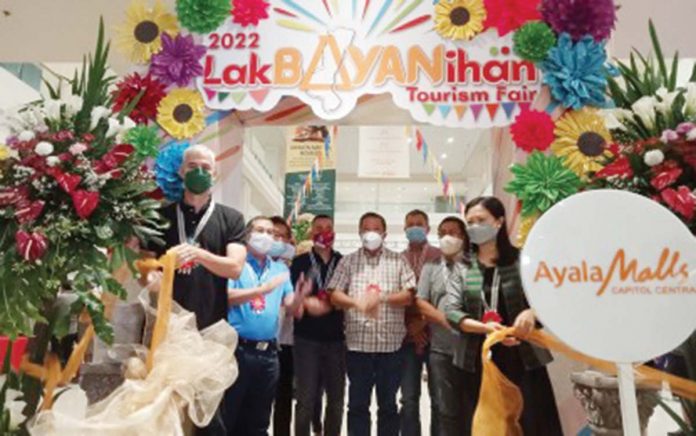 Negros Occidental’s Gov. Eugenio Jose Lacson (left) and Department of Tourism – Western Visayas director Cristine Mansinares (right) lead the opening of the Lakbayanihan Tourism Fair 2022 in Bacolod City on May 16. The province’s first tourism fair in two years, the event, which runs until May 29, promotes tourism attractions across the province's 32 city and municipal governments, including the capital city of Bacolod, in a bid to revive the local tourism industry. PNA PHOTO BY NANETTE GUADALQUIVER