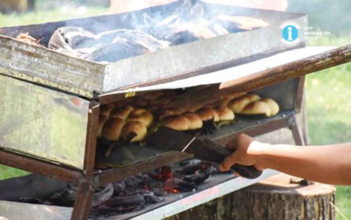 “Salbaro” is being baked on an open-top oven fired by coconut husks during a cooking demonstration in San Carlos City, Negros Occidental. The coconut-filled bread has been recognized by the northern Negros city as a heritage delicacy. PHOTO COURTESY OF NEGOCC-SAN CARLOS CITY INFORMATION OFFICE