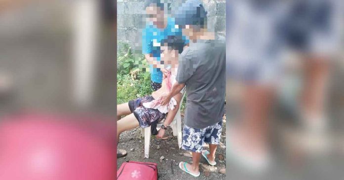 Concerned neighbors restrain a disoriented father after killing his son in Barangay Bubog, Numancia, Aklan. PHOTO BY THE NUMANCIA MDRRMO