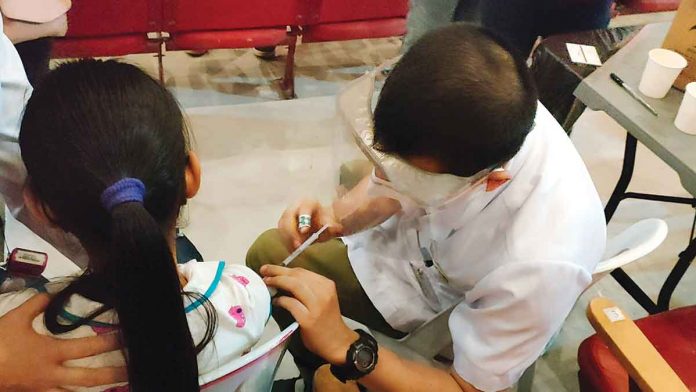 A young girl receives her shot of the vaccine against coronavirus disease 2019. COVID-19 vaccines are safe, according to the Department of Health. They have been given Emergency Use Authorization by the Food and Drug Administration. PN PHOTO