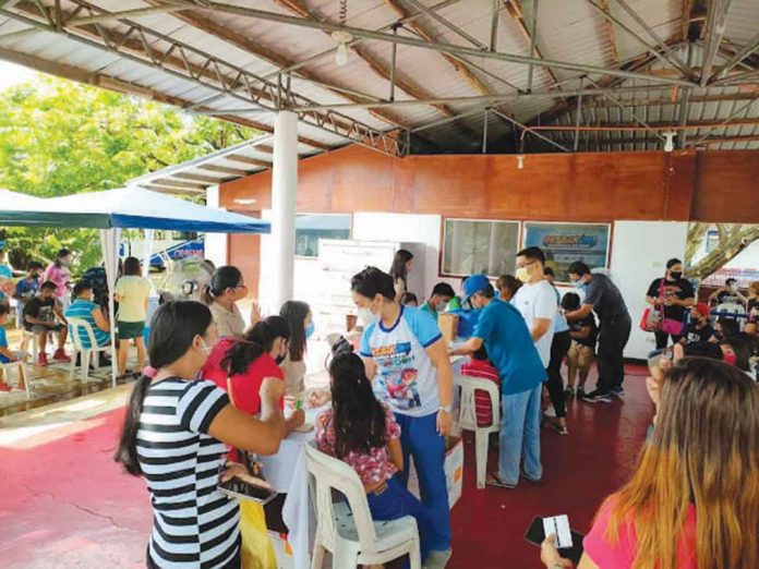 People gather at a vaccination site against coronavirus disease in Aklan.