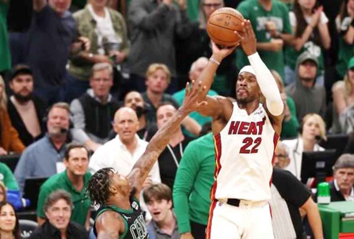 Miami Heat’s Jimmy Butler pulls up for a basket while being defended by Boston Celtics’ Marcus Smart. AP