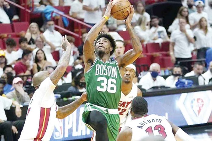 Boston Celtics’ Marcus Smart attacks the defense of Miami Heat's PJ Tucker for an inside hit. AP