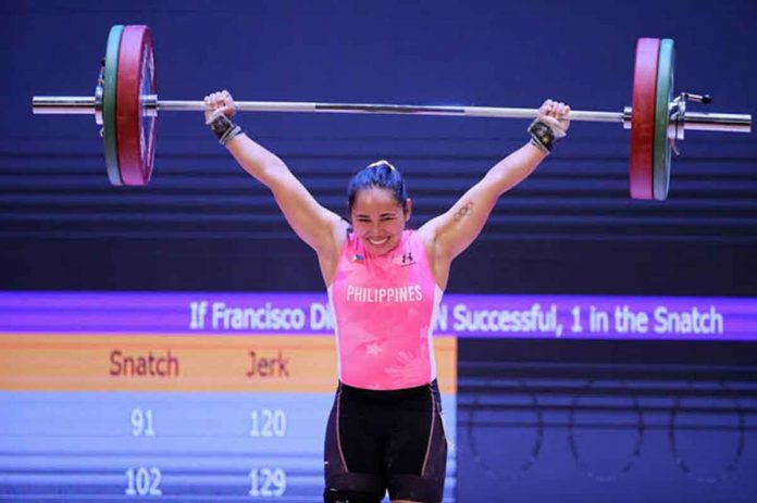 Filipina weightlifter Hidilyn Diaz was all smiles after clearing her lift during the 31st Southeast Asian Games women’s -55 kilogram category. PHOTO BY LUONG THAI LINH/EPA-EFE