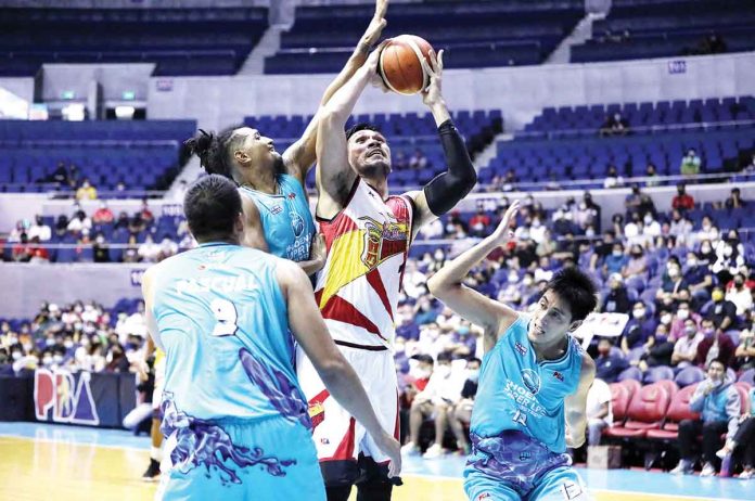 San Miguel Beermen’s June Mar Fajardo attempts from the inside amid the defense of Phoenix Super LPG Fuel Masters’ Jayson Perkins, Elvin Jake Pascual and RJ Jazul. PBA MEDIA BUREAU