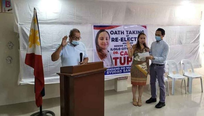 Councilor Candice Magdalane Tupas of Iloilo City takes her oath of office before Barangay Captain Sergio Causing of Mandurriao district. With Tupas is her husband, former councilor Nielex Tupas. PHOTO FROM THE FB PAGE OF COUNCILOR CANDICE MAGDALANE TUPAS