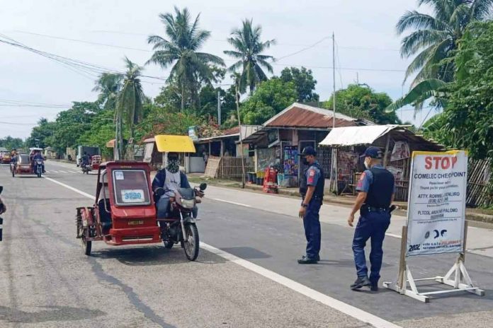 A tricycle stops at a checkpoint in Roxas City for inspection. PIA-CAPIZ PHOTO