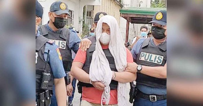 After his inquest, stabbing suspect Mark Archie Torrefiel is whisked away by policemen to the Kalibo police station in Kalibo, Aklan.