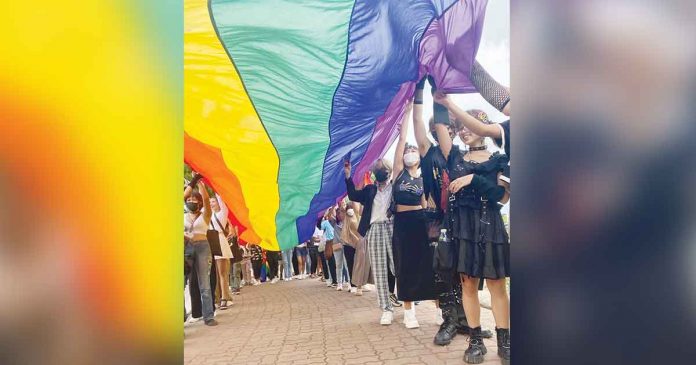 Members of the LGBTQ community of Iloilo march while holding the rainbow flag, the universal symbol of lesbian, gay, bisexual, transgender and queer social movement. The flag’s colors reflect the diversity of the LGBT community and the wide spectrum of human sexuality and gender. PHOTO FROM ILOILO PRIDE TEAM FACEBOOK PAGE