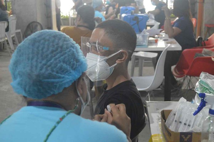 A teenager gets his shot of the vaccine against coronavirus disease at a vaccination center in Iloilo City. For children between 12 to 17 years old in the metro, the vaccination is high at 94.88 percent of the 51,580 target population. PN PHOTO