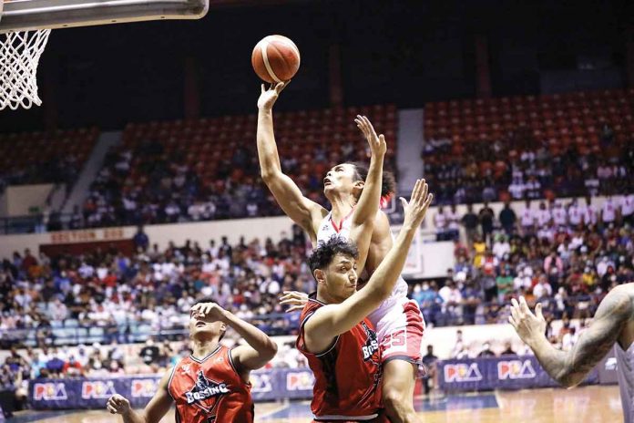 Barangay Ginebra San Miguel Kings’ Japeth Aguilar runs over the defense of Blackwater Bossing’s Yousef Taha for an inside attempt. PBA MEDIA BUREAU