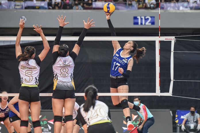 Ateneo de Manila University Blue Eagles’ Faith Nisperos will a drop shot against two University of Santo Tomas Golden Tigresses defenders. UAAP MEDIA BUREAU