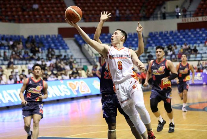 NorthPort Batang Pier’s Robert Bolick Jr. goes for a layup with Rain or Shine Elasto Painters defenders trying to give chase. PBA MEDIA BUREAU